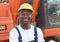Laughing african construction worker with red excavator