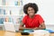 Laughing afro american male student learning at desk