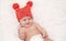 Laughing baby in red cap