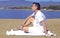 Laughing beach guy in white shorts and shirt. Entrepreneur enjoys staying on the beach. Man on beach lying in sand looking to side