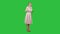 Laughing beautiful young woman in pink dress standing on a Green Screen, Chroma Key.