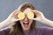 Laughing beautiful young woman with zesty lemon slices on eyes
