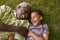 Laughing boy and granddad lying on grass, overhead close up