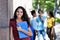 Laughing brazilian female student with group of young adults