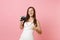 Laughing bride woman in white wedding dress showing thumb up hold retro vintage photo camera, choosing staff