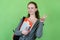 Laughing british female student with paperwork and backpack