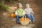 Laughing Brother and Sister Children Sitting on Wood Steps with Pumpkins