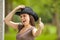 Laughing brunette woman with cowboy hat