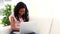 Laughing brunette woman using a laptop