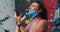 Laughing caucasian woman with face mask using smartphone at indoor climbing wall