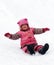 A laughing child sliding in the snow