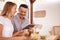 Laughing couple with touchpad and beers