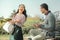 Laughing dark-haired girl in striped shirt having fun with her boyfriend