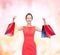 Laughing elegant woman in dress with shopping bags