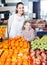 Laughing family customers buying fruits