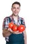 Laughing farmer offering fresh tomatoes