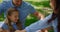 Laughing father tickling son on picnic blanket closeup. Parents play with kids.