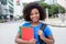 Laughing female student from Africa in blue shirt in city