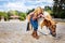 Laughing girl having much fun with little cute pony with braid