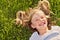 Laughing girl lying in grass