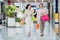 Laughing girls carrying bags with purchases in shopping mall