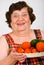 Laughing grandma holding tomatoes