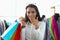 Laughing happy joyful woman with shopping bags in fashionable clothing store