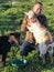 Laughing and Happy Man Petting Goats