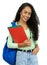 Laughing hispanic student with dental aligner and books and backpack