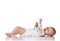 Laughing infant baby toddler in white bodysuit is lying on his back, holding hands up, waving, happy screaming on white
