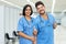 Laughing latin american male and female nurses at vaccination station