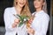 Laughing lesbian couple holding Christmas star decoration at home