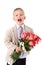 Laughing little gentleman standing with big bouquet of red roses