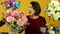 Laughing mature woman dancing and sniffing flowers