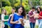 Laughing mexican female university student with group of students