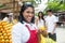 Laughing mexican saleswoman with customers on a farmers market