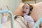 Laughing mixed race tween girl in hospital bed