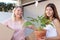 Laughing mom and daughter moving things into new house