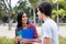 Laughing native latin american female student talking with caucasian friend