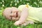 Laughing Newborn Baby Laying in Grass OUtside