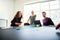 Laughing office colleagues playing table tennis during a work br