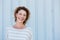 Laughing older woman standing by wall outside