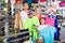 Laughing parents with boy in sport store