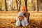 Laughing, pleased, relaxed, mischief mother and daughter in warm hats and coats lying, girl on woman in autumn woods