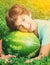 Laughing preteen handsome boy with water melon