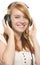 Laughing redhead girl with headphones listening to