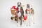 Laughing santa whippets with christmas cart