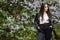 Laughing and smiling beautiful happy artistic young model girl with long hair in summer lilac garden with flowers posing