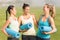 Laughing sporty women with exercise mats