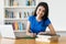 Laughing turkish female student at desk